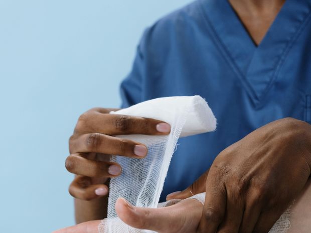 Nurse wrapping an injured hand